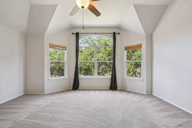 a view of a livingroom with a ceiling fan and window