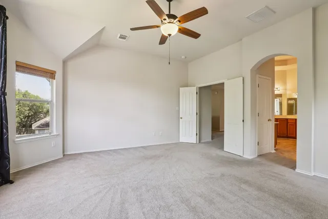 a spacious bathroom with a granite countertop sink mirror and a bathtub
