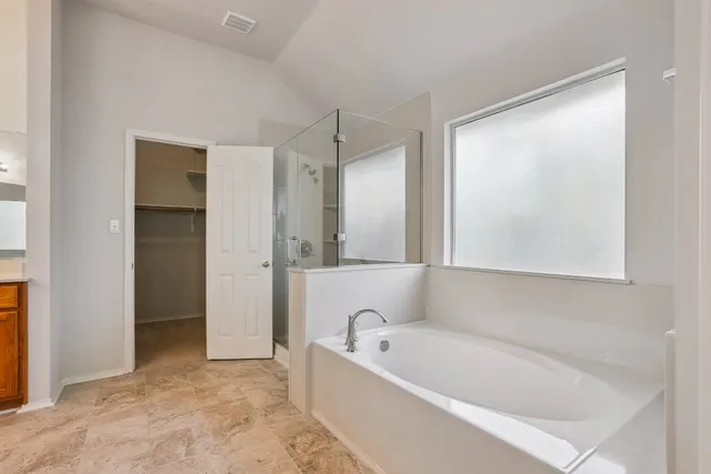 a view of walk in closet with empty racks