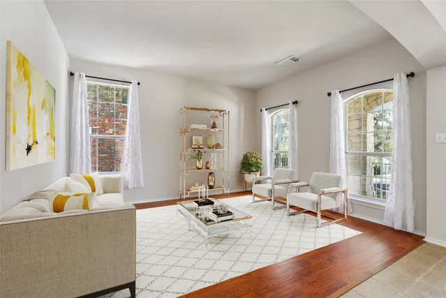 a living room with furniture and floor to ceiling windows