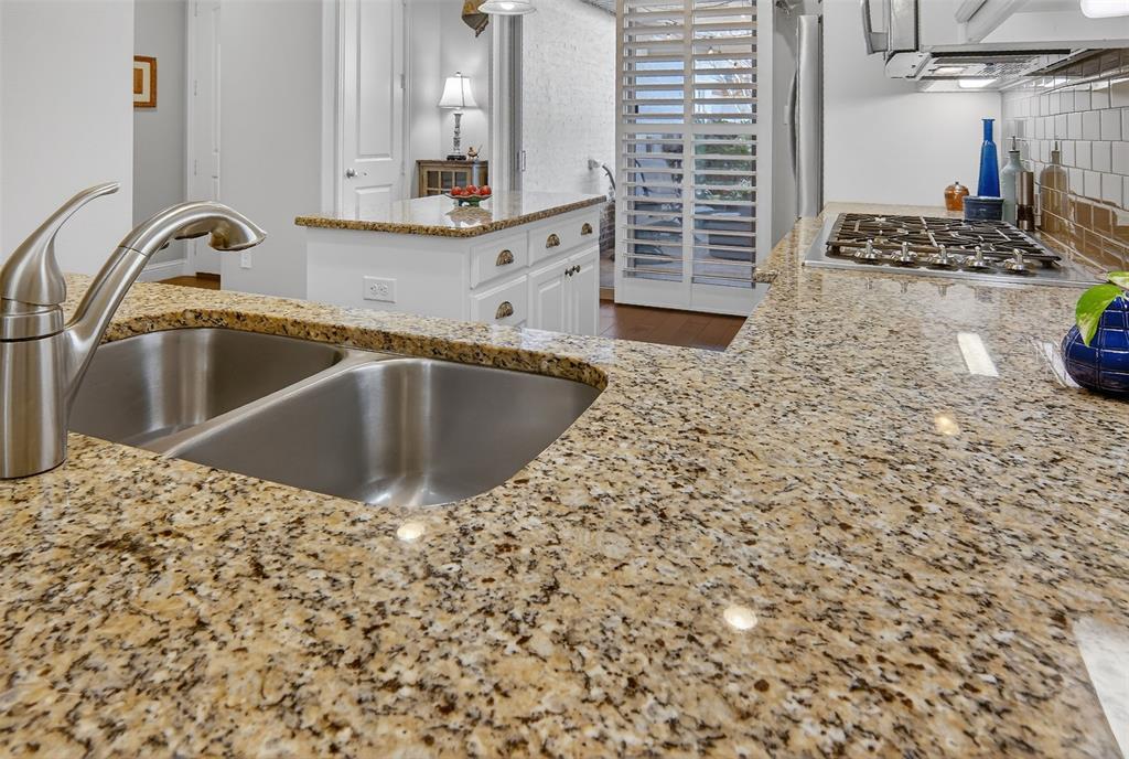 825 Milton Way Coppell, TX 75019 - Photo 11 of 35 a kitchen with kitchen island a sink stove and granite counter top