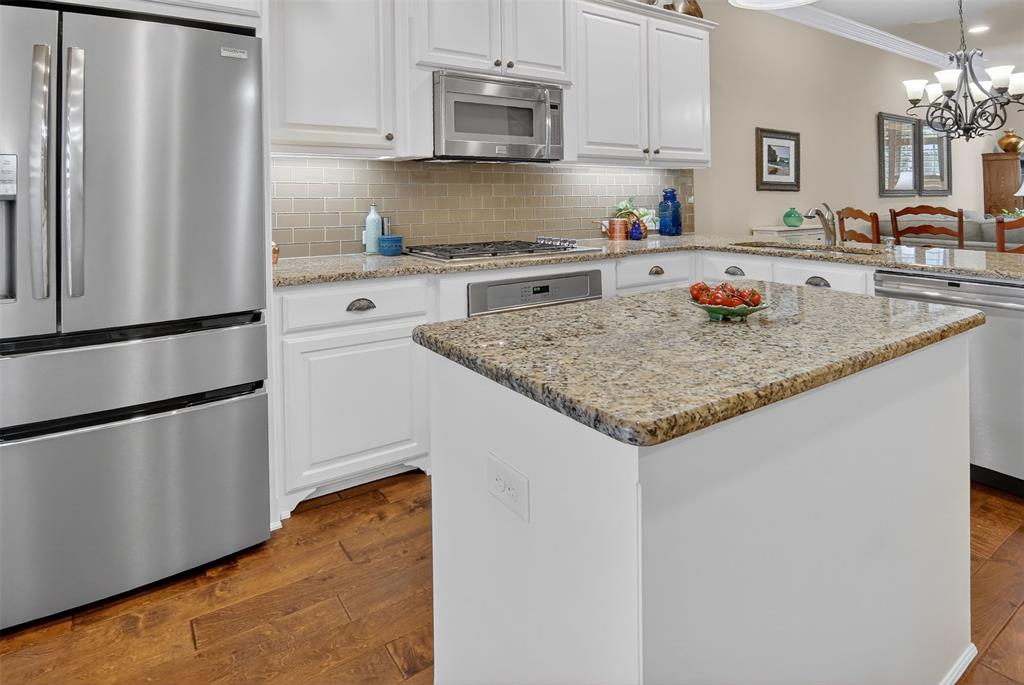 825 Milton Way Coppell, TX 75019 - Photo 12 of 35 a kitchen with stainless steel appliances granite countertop a refrigerator a sink and white cabinets