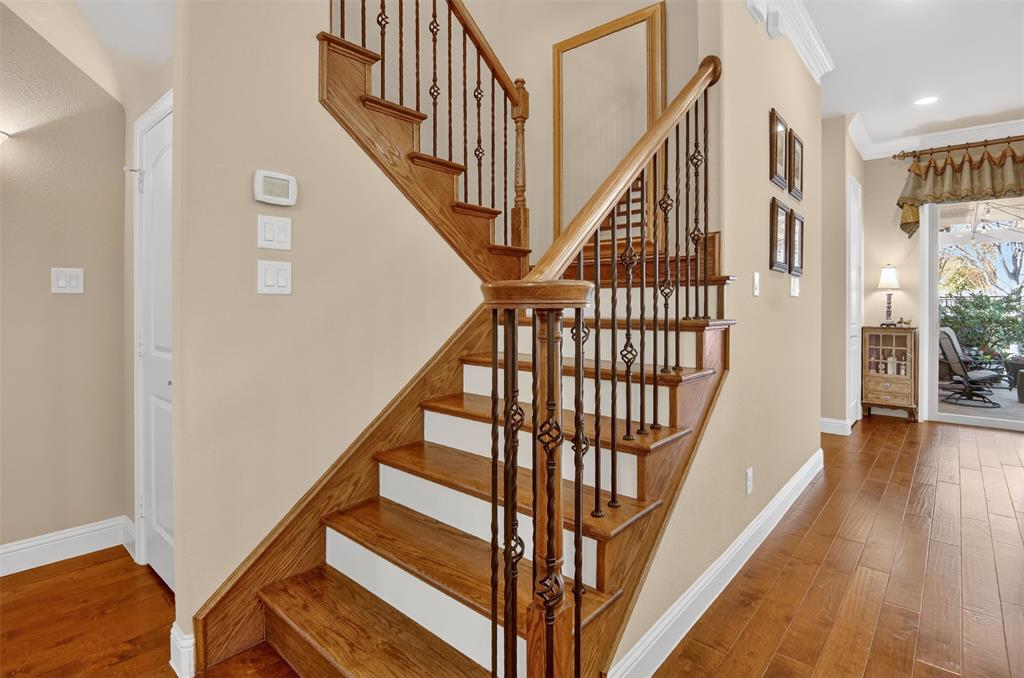 825 Milton Way Coppell, TX 75019 - Photo 20 of 35 a view of staircase with lots of frames on wall and wooden floor