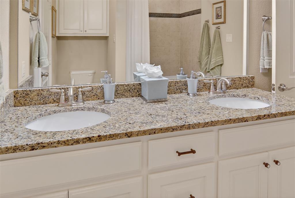 825 Milton Way Coppell, TX 75019 - Photo 26 of 35 a bathroom with double vanity sinks and a granite granite tub