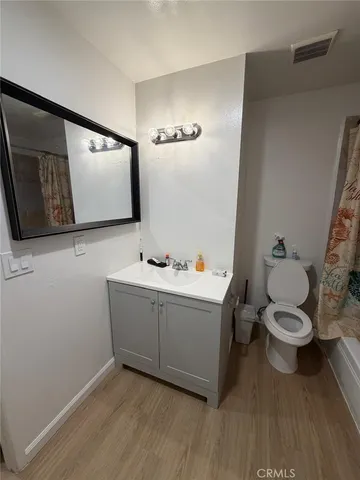 a view of bathroom with a toilet sink and mirror