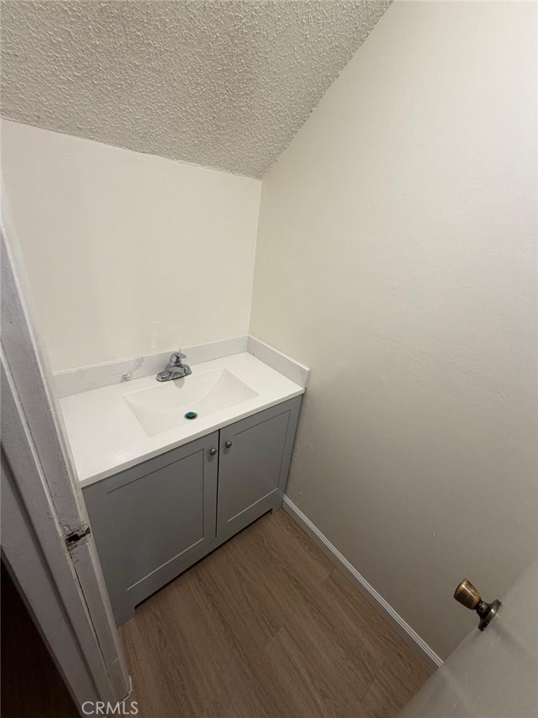 1602 North King Street, Unit S4 Santa Ana, CA 92706 - Photo 15 of 22 a bathroom with a sink and mirror