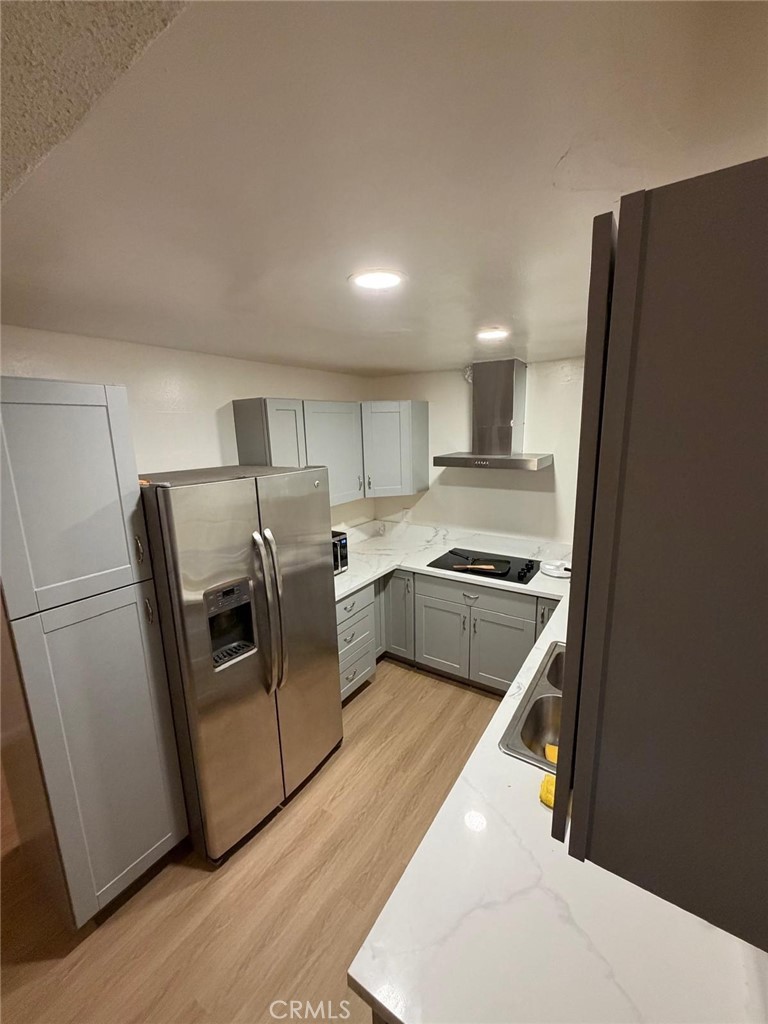 1602 North King Street, Unit S4 Santa Ana, CA 92706 - Photo 2 of 22 a kitchen with white cabinets and stainless steel appliances