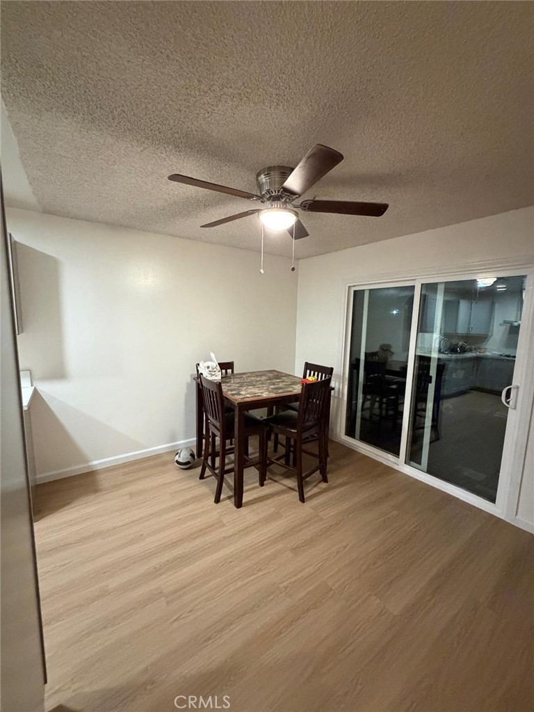 1602 North King Street, Unit S4 Santa Ana, CA 92706 - Photo 3 of 22 a view of a dining room with furniture and wooden floor