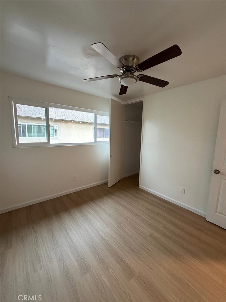 1602 North King Street, Unit S4 Santa Ana, CA 92706 - Photo 9 of 22 an empty room with wooden floor fan and windows
