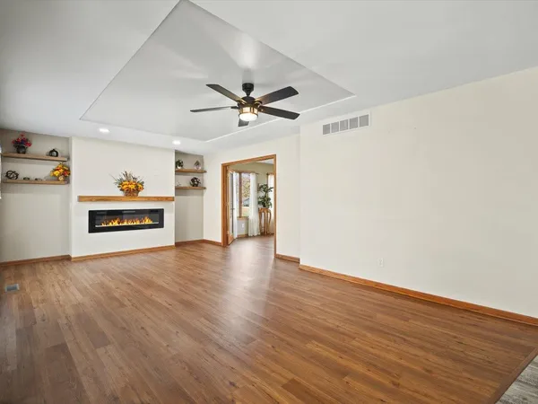 a view of a livingroom with hardwood floor and a ceiling fan