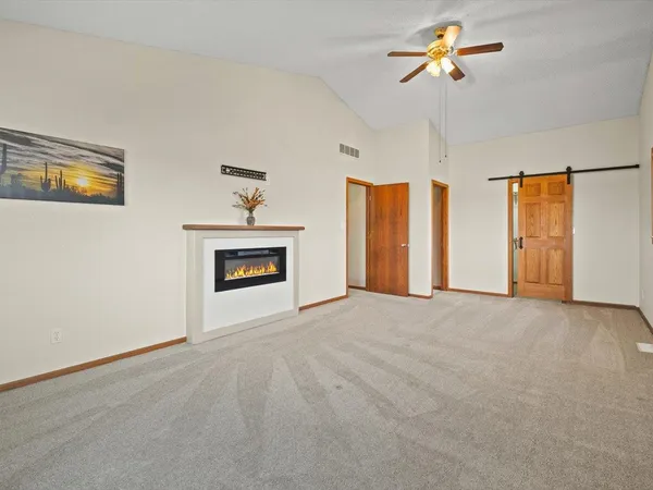 a kitchen with stainless steel appliances kitchen island granite countertop a dining table chairs and granite counter tops