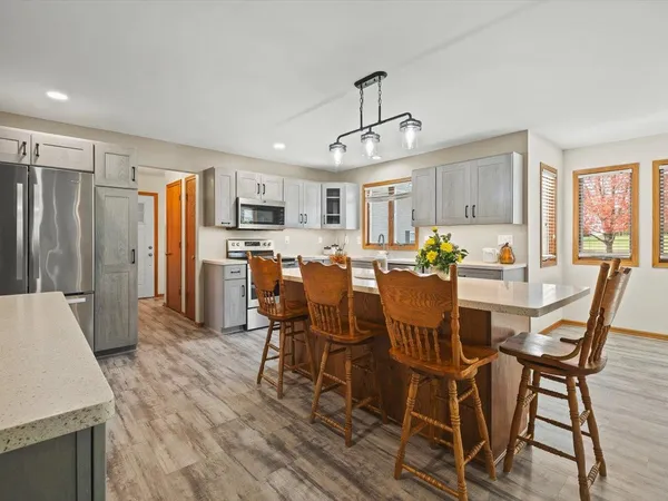 a living room with furniture and large windows