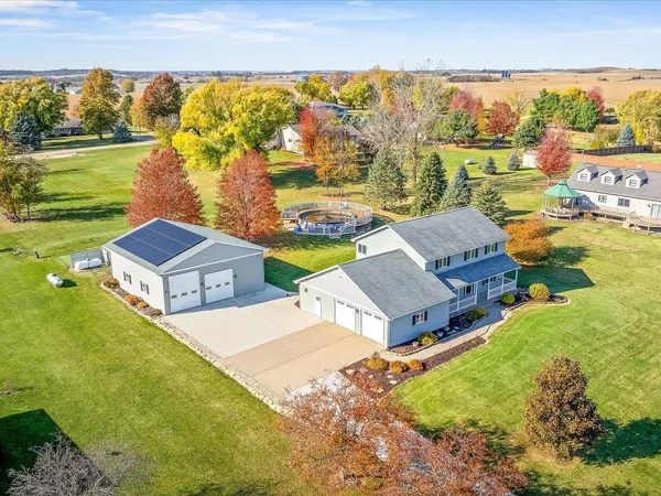 an aerial view of residential houses with outdoor space and swimming pool