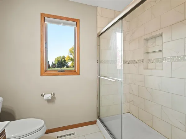 an empty room with a chandelier fan