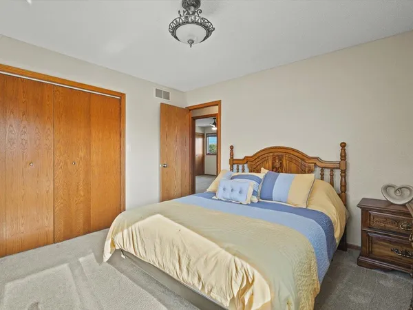a view of a big room with a ceiling fan and a window
