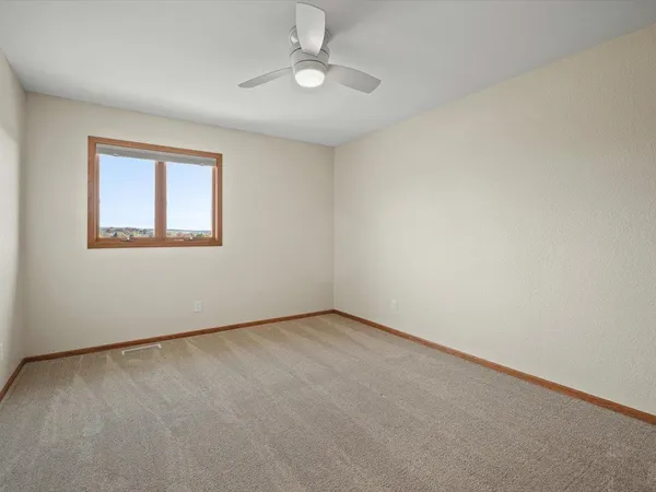 a view of a hallway with wooden floor and a wardrobe