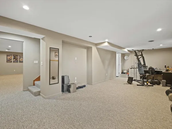 a hallway with sink and mirror