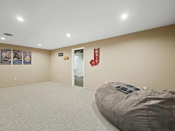a view of a hallway with wooden floor and entryway