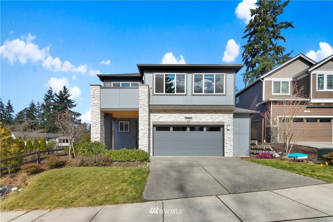 a front view of a house with a yard and garage