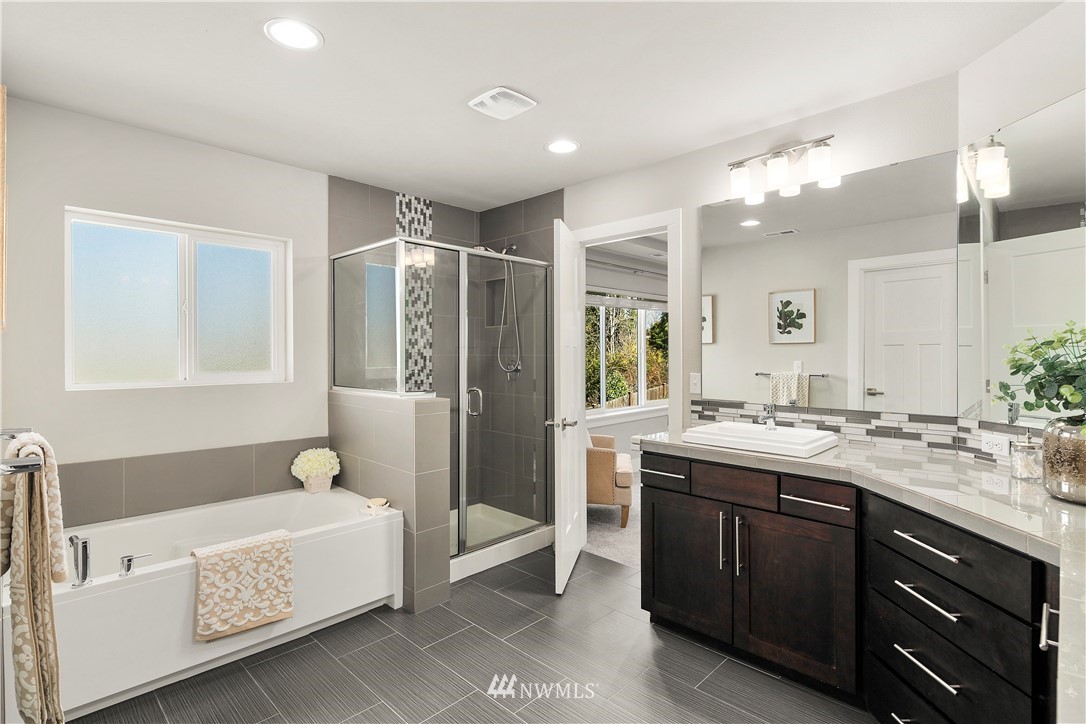 207 176th Place Southwest Bothell, WA 98012 - Photo 17 of 36 a bathroom with a granite countertop tub sink shower and mirror