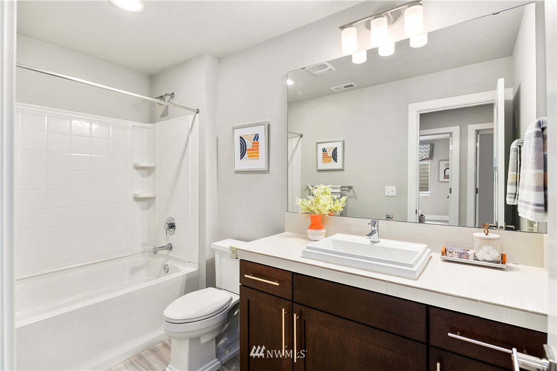 207 176th Place Southwest Bothell, WA 98012 - Photo 22 of 36 a bathroom with a sink toilet double vanity and shower