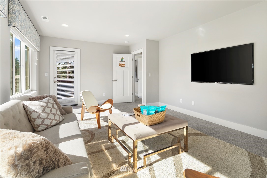 207 176th Place Southwest Bothell, WA 98012 - Photo 29 of 36 a living room with furniture and a flat screen tv