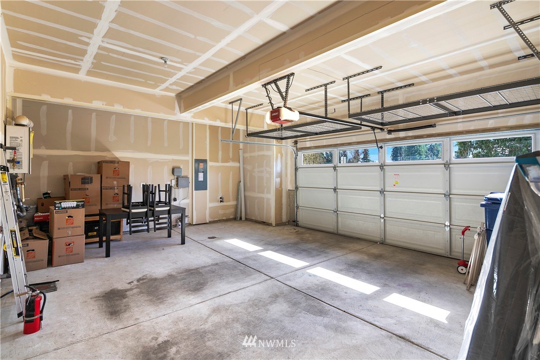 207 176th Place Southwest Bothell, WA 98012 - Photo 31 of 36 a view of a garage with wooden table and chairs