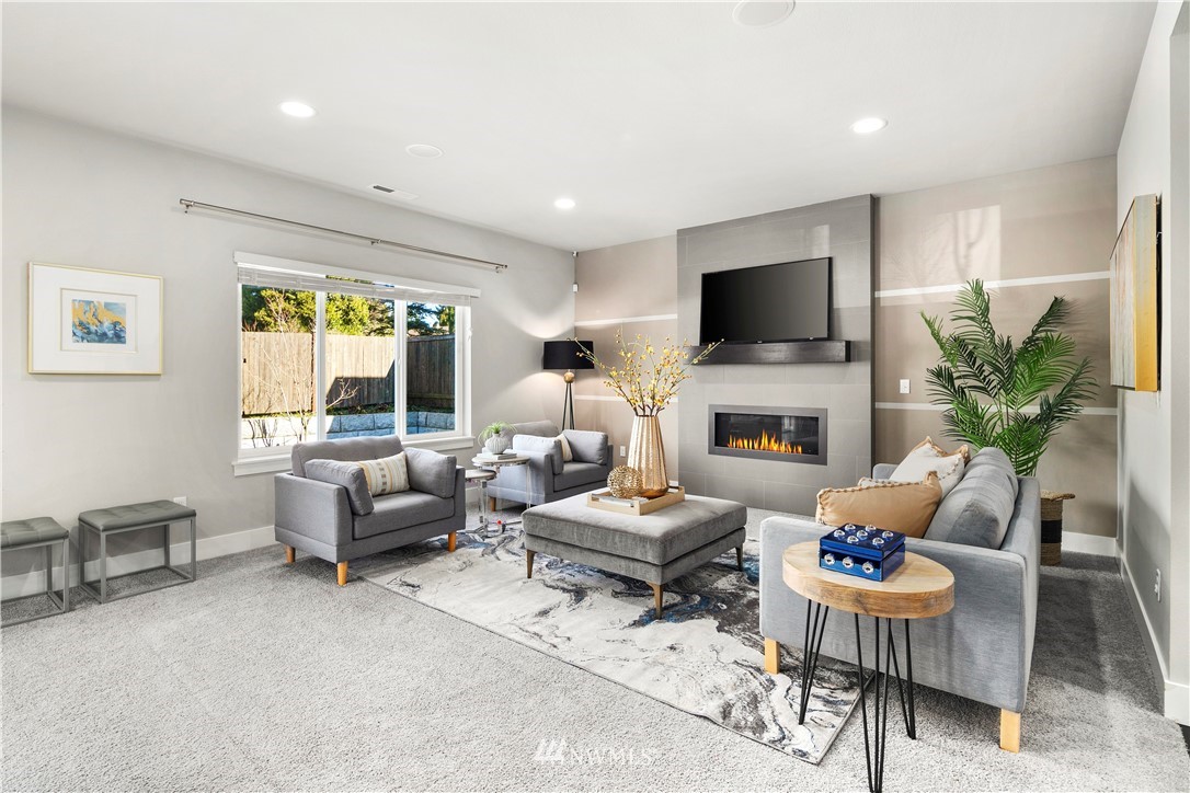 207 176th Place Southwest Bothell, WA 98012 - Photo 5 of 36 a living room with fireplace furniture and a flat screen tv
