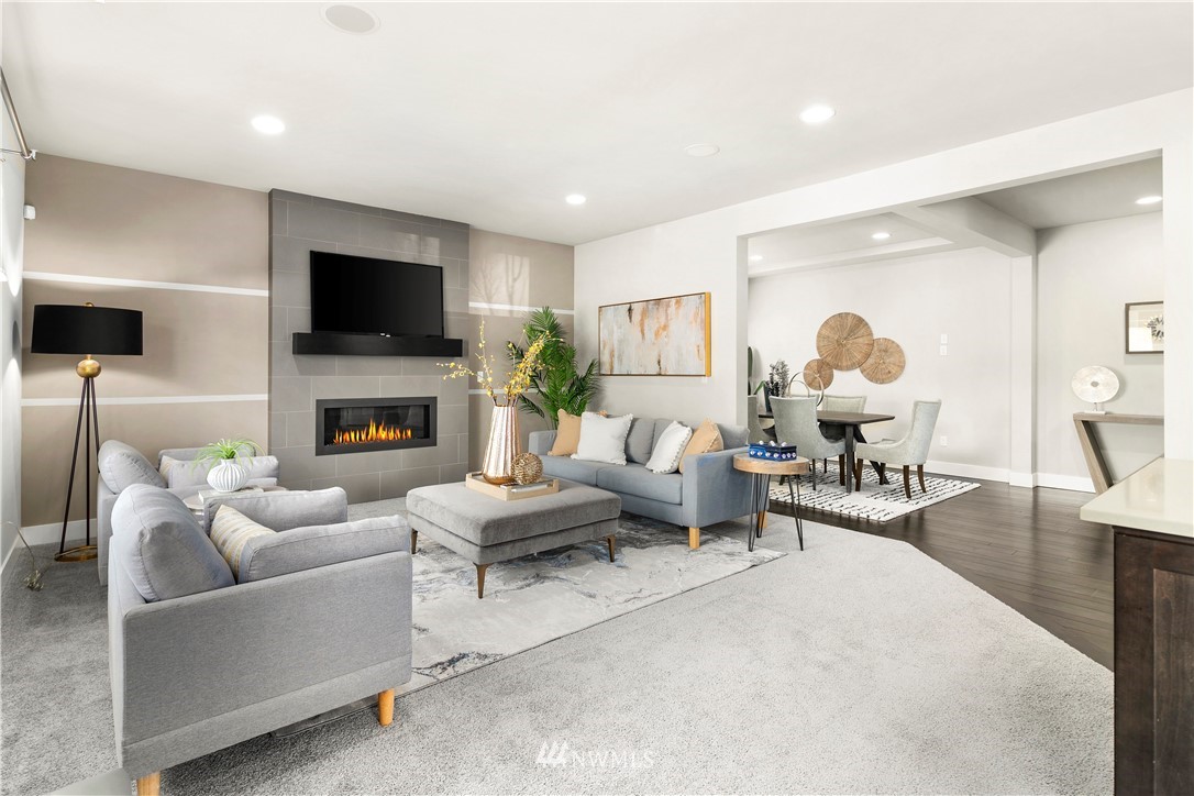 207 176th Place Southwest Bothell, WA 98012 - Photo 6 of 36 a living room with furniture a fireplace and a flat screen tv