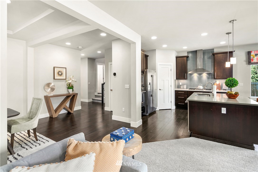 207 176th Place Southwest Bothell, WA 98012 - Photo 7 of 36 a living room with couches and kitchen view with wooden floor