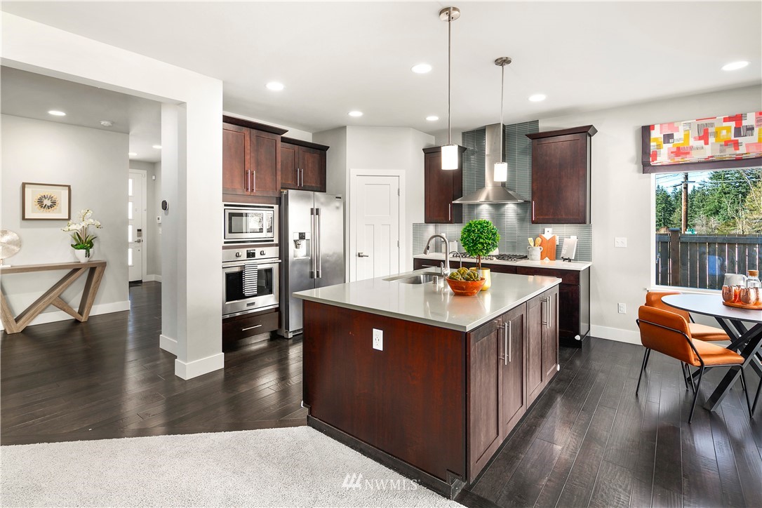 207 176th Place Southwest Bothell, WA 98012 - Photo 10 of 36 a kitchen with stainless steel appliances granite countertop a stove and a refrigerator