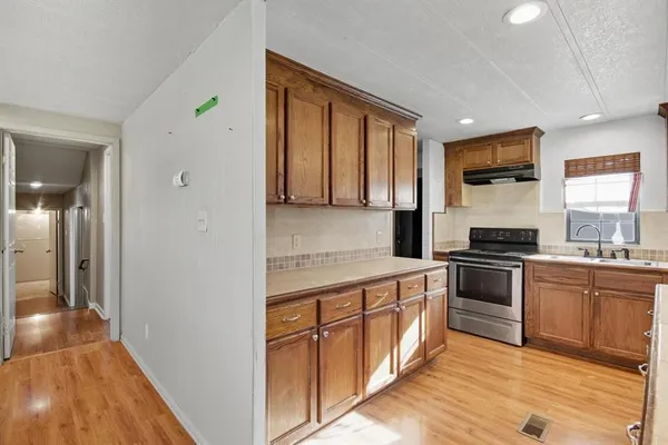 a kitchen with stainless steel appliances granite countertop a stove and a sink