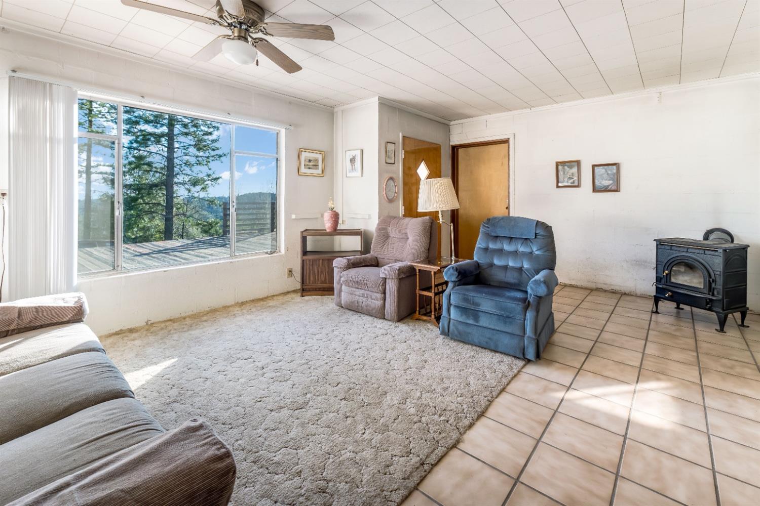 36659 Douglas Ranger Station Road North Fork, CA 93643 - Photo 11 of 38 a living room with furniture and a floor to ceiling window