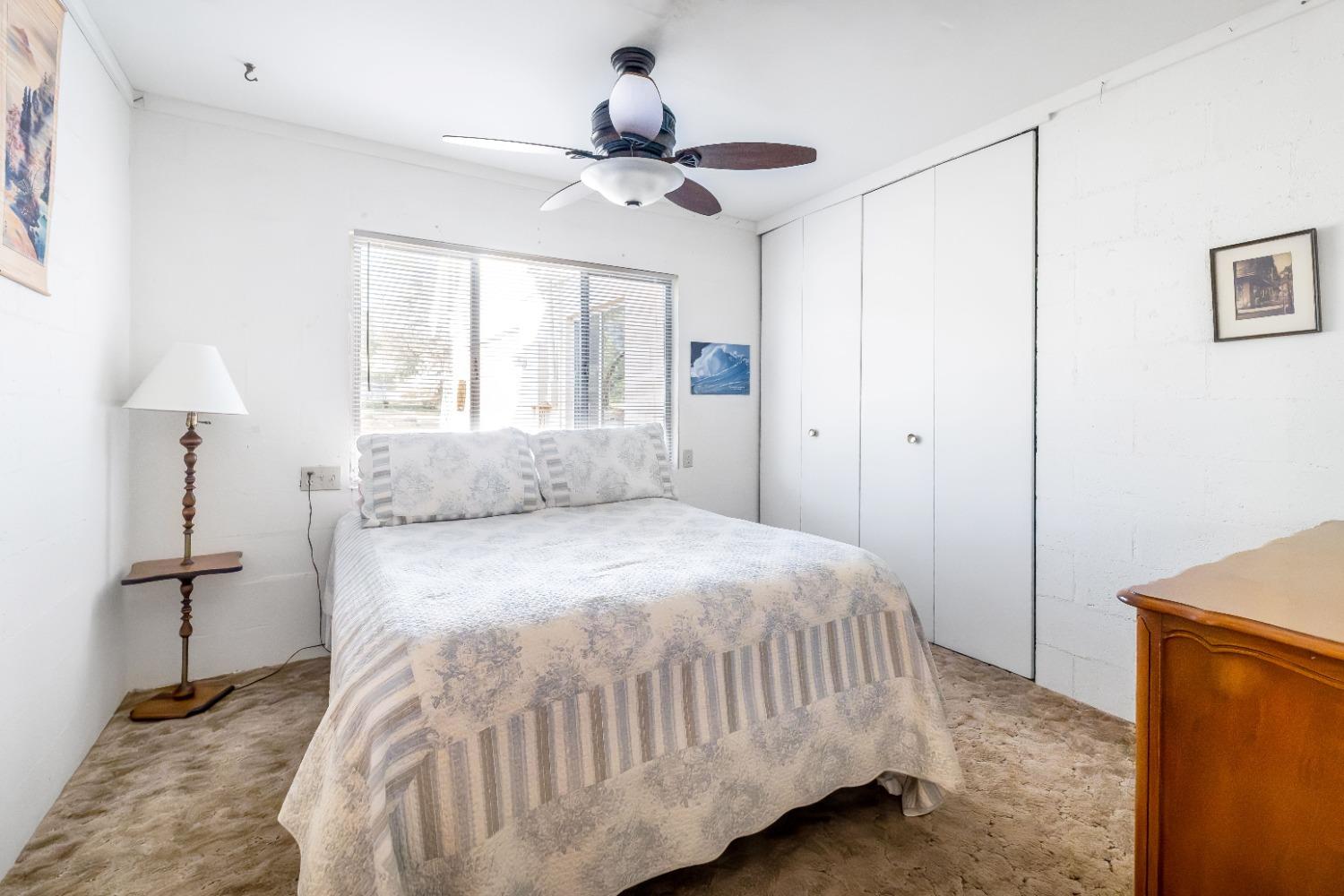 36659 Douglas Ranger Station Road North Fork, CA 93643 - Photo 13 of 38 a bedroom with a bed and a window