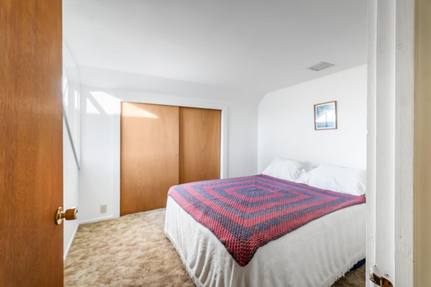 36659 Douglas Ranger Station Road North Fork, CA 93643 - Photo 16 of 38 a bedroom with a bed and a window