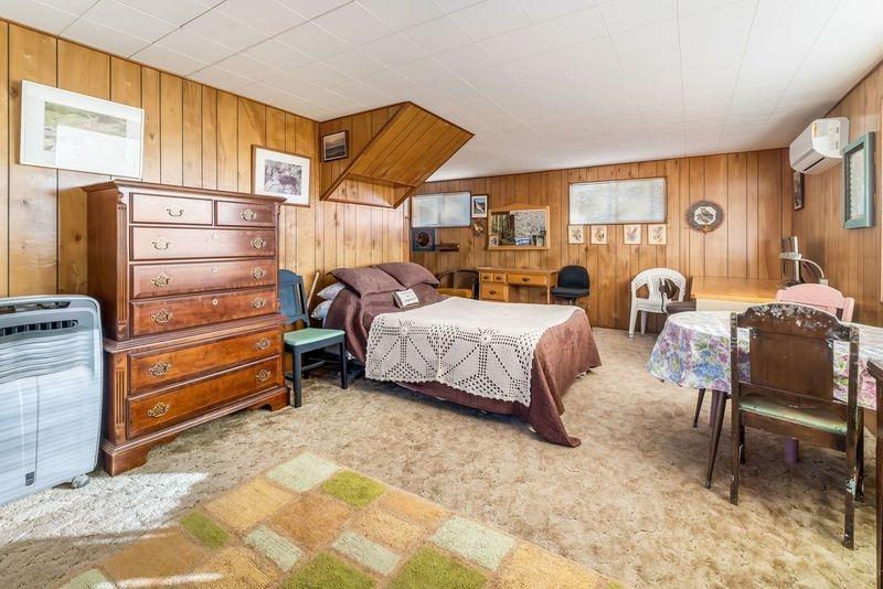 36659 Douglas Ranger Station Road North Fork, CA 93643 - Photo 24 of 38 a bedroom with a bed and a chair