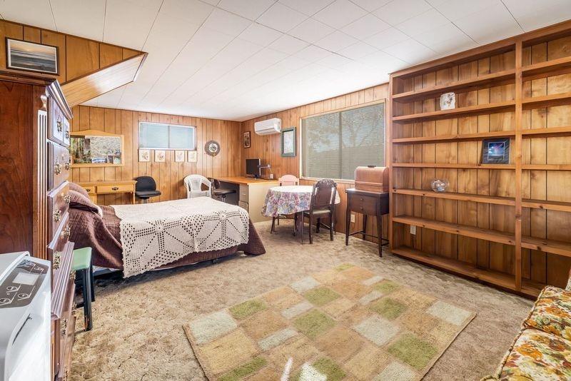 36659 Douglas Ranger Station Road North Fork, CA 93643 - Photo 25 of 38 a bedroom with furniture and a book shelf