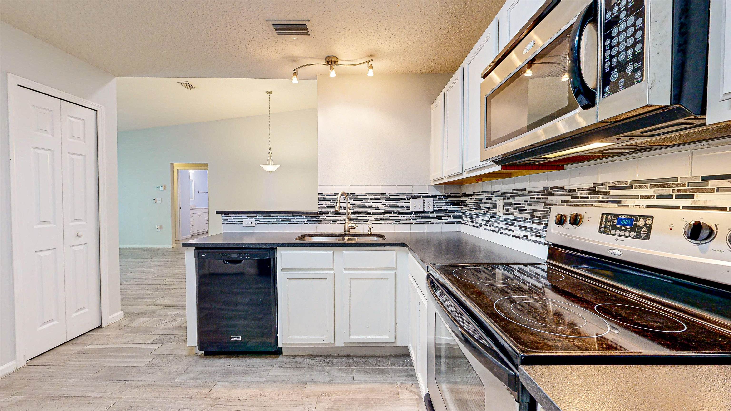 2724 Golden Lake Loop St. Augustine, FL 32084 - Photo 12 of 43 a kitchen with a stove and a sink