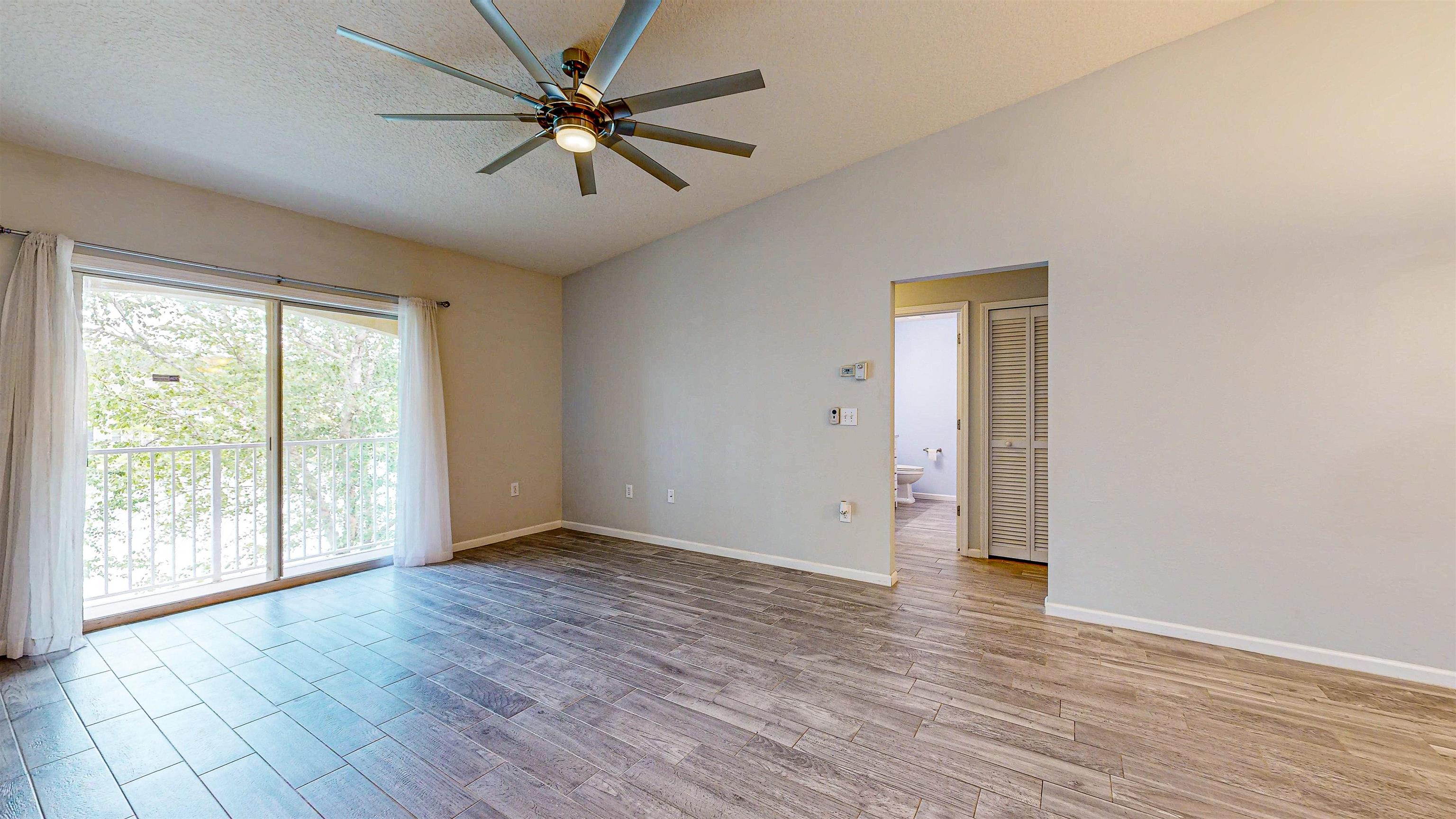 2724 Golden Lake Loop St. Augustine, FL 32084 - Photo 13 of 43 a view of an empty room with window and wooden floor