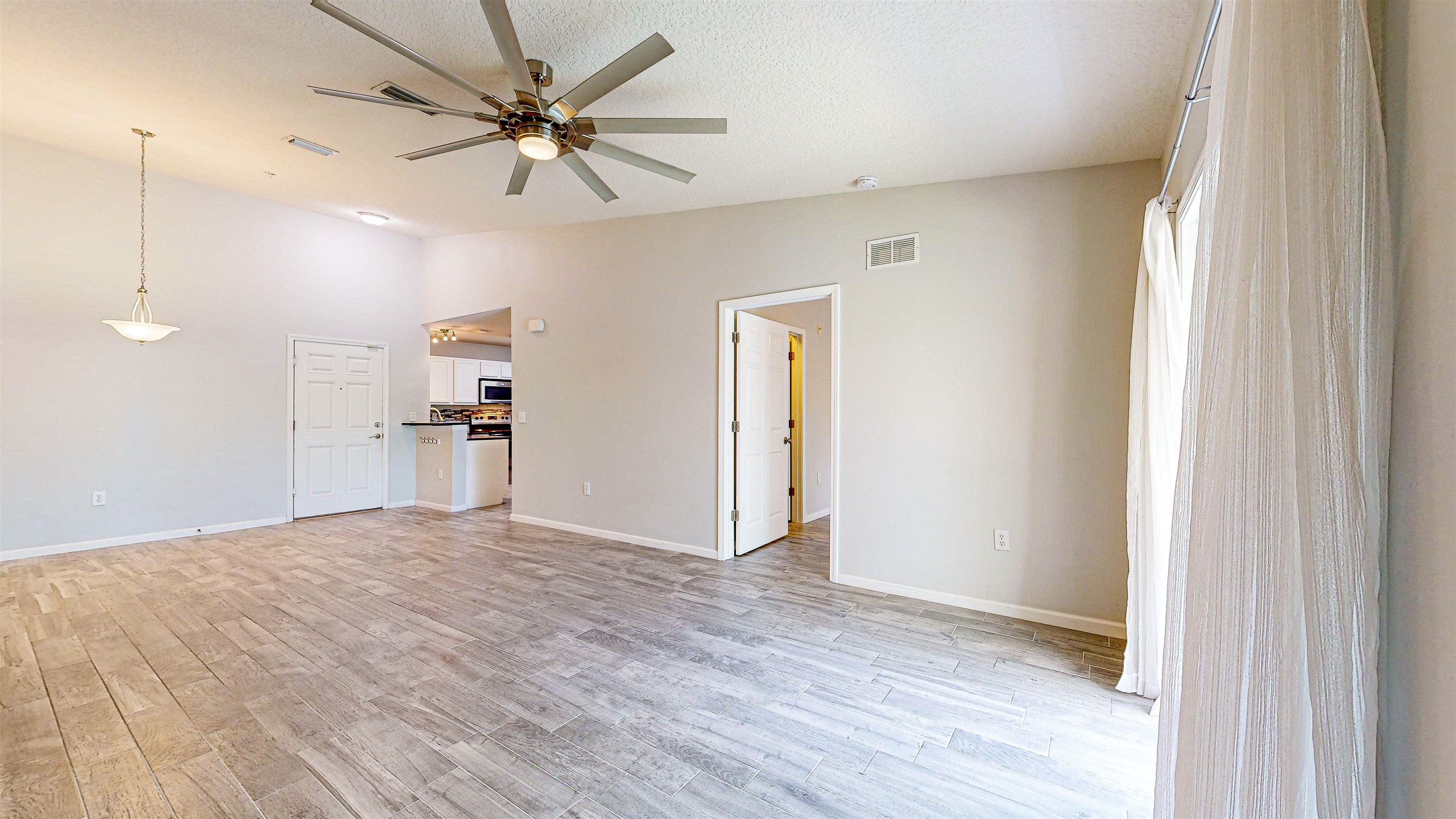2724 Golden Lake Loop St. Augustine, FL 32084 - Photo 15 of 43 a view of empty room with wooden floor and a ceiling fan