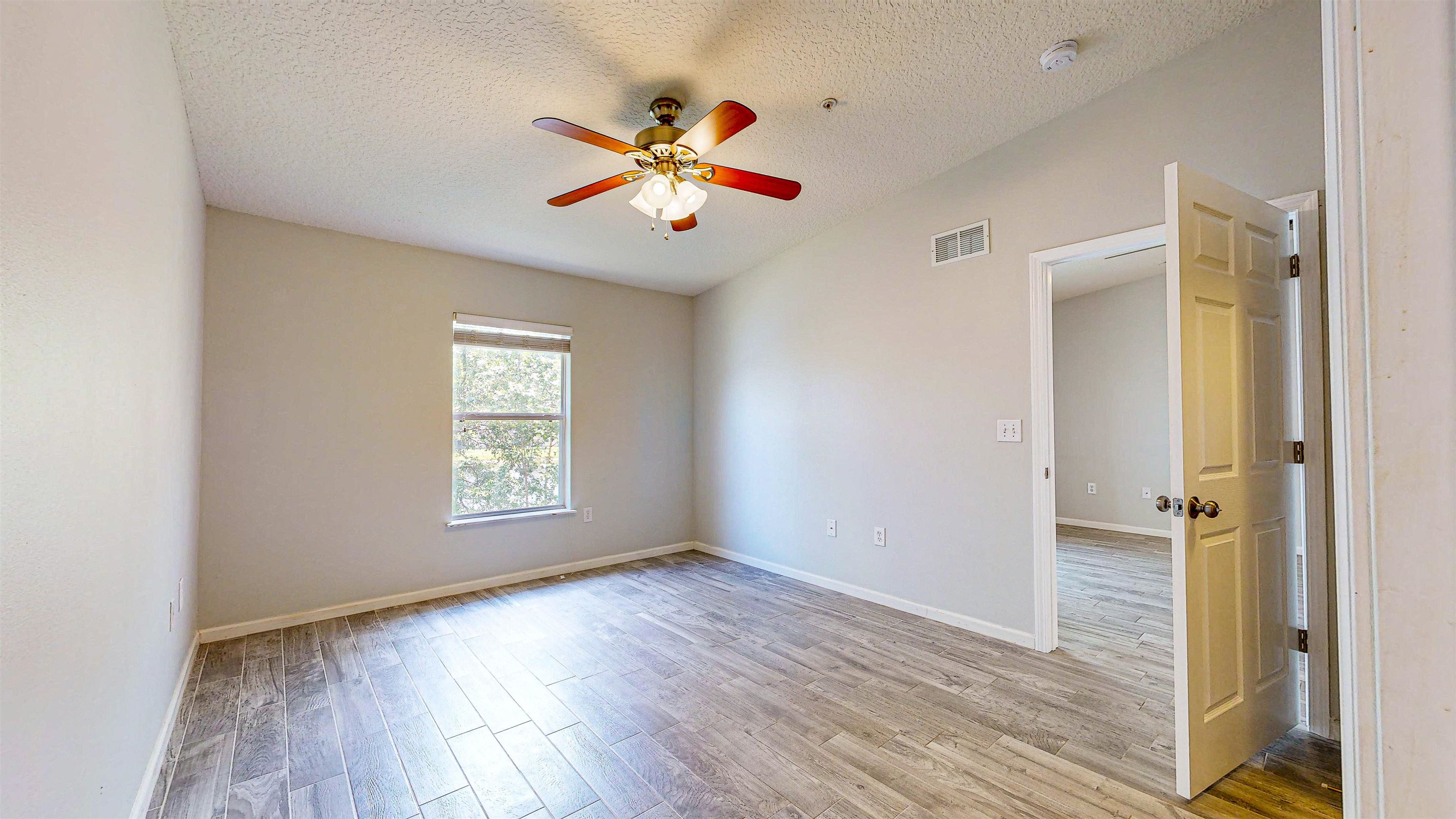 2724 Golden Lake Loop St. Augustine, FL 32084 - Photo 21 of 43 a view of an empty room with wooden floor and a window