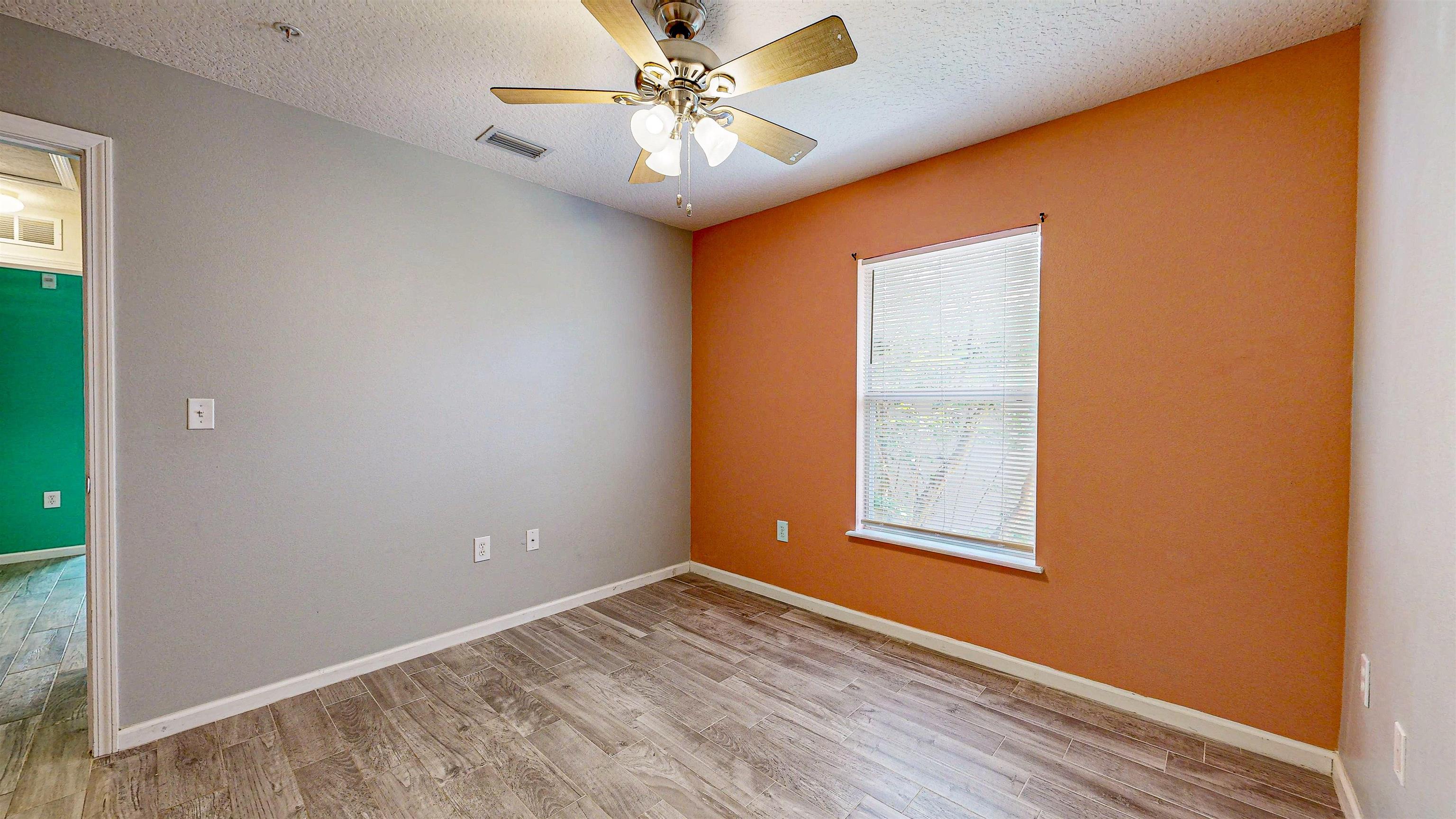2724 Golden Lake Loop St. Augustine, FL 32084 - Photo 29 of 43 an empty room with a window and a ceiling fan