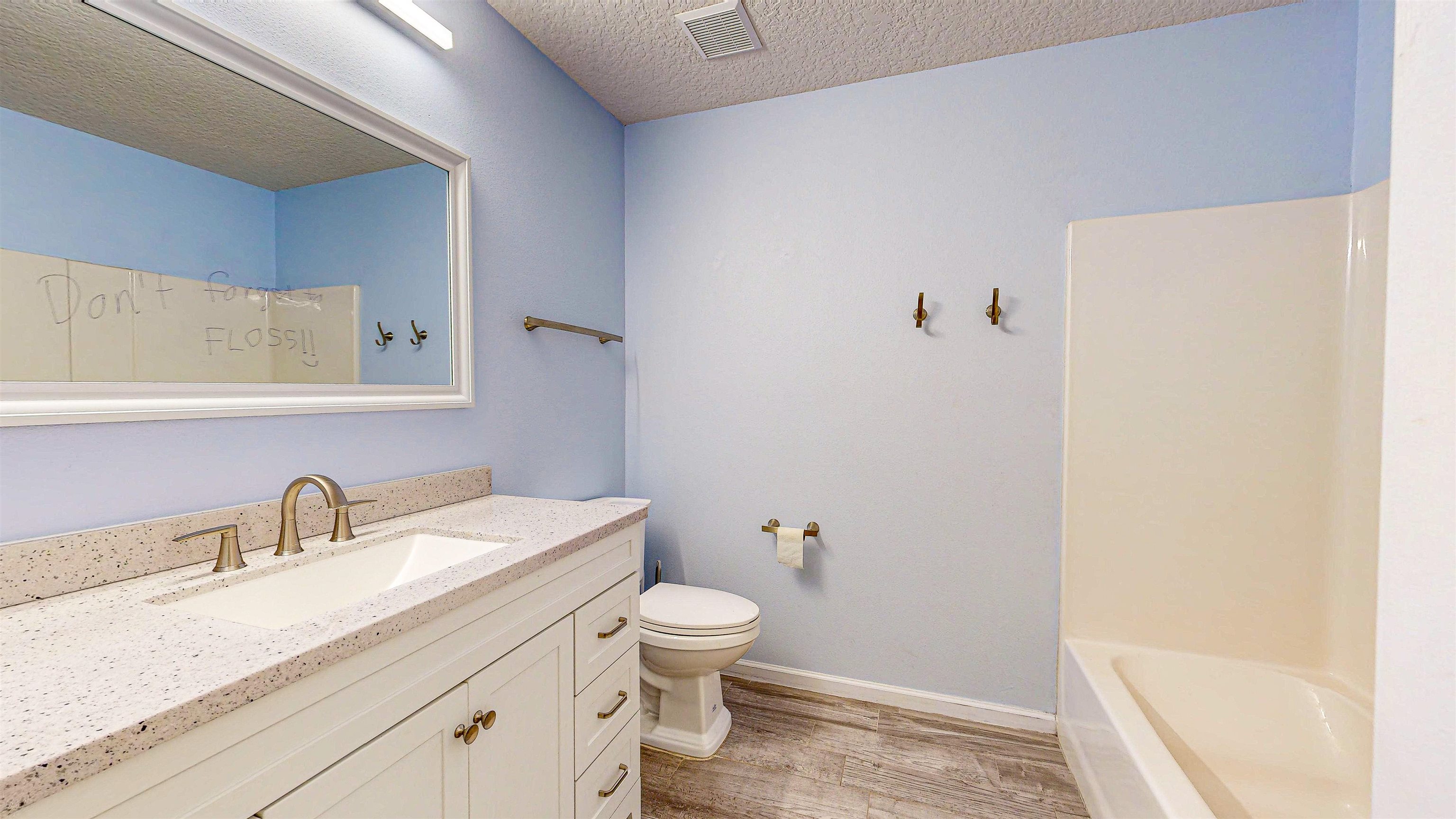 2724 Golden Lake Loop St. Augustine, FL 32084 - Photo 32 of 43 a bathroom with a granite countertop sink a toilet and a mirror