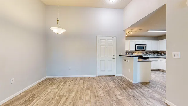 a view of kitchen with microwave and white cabinets