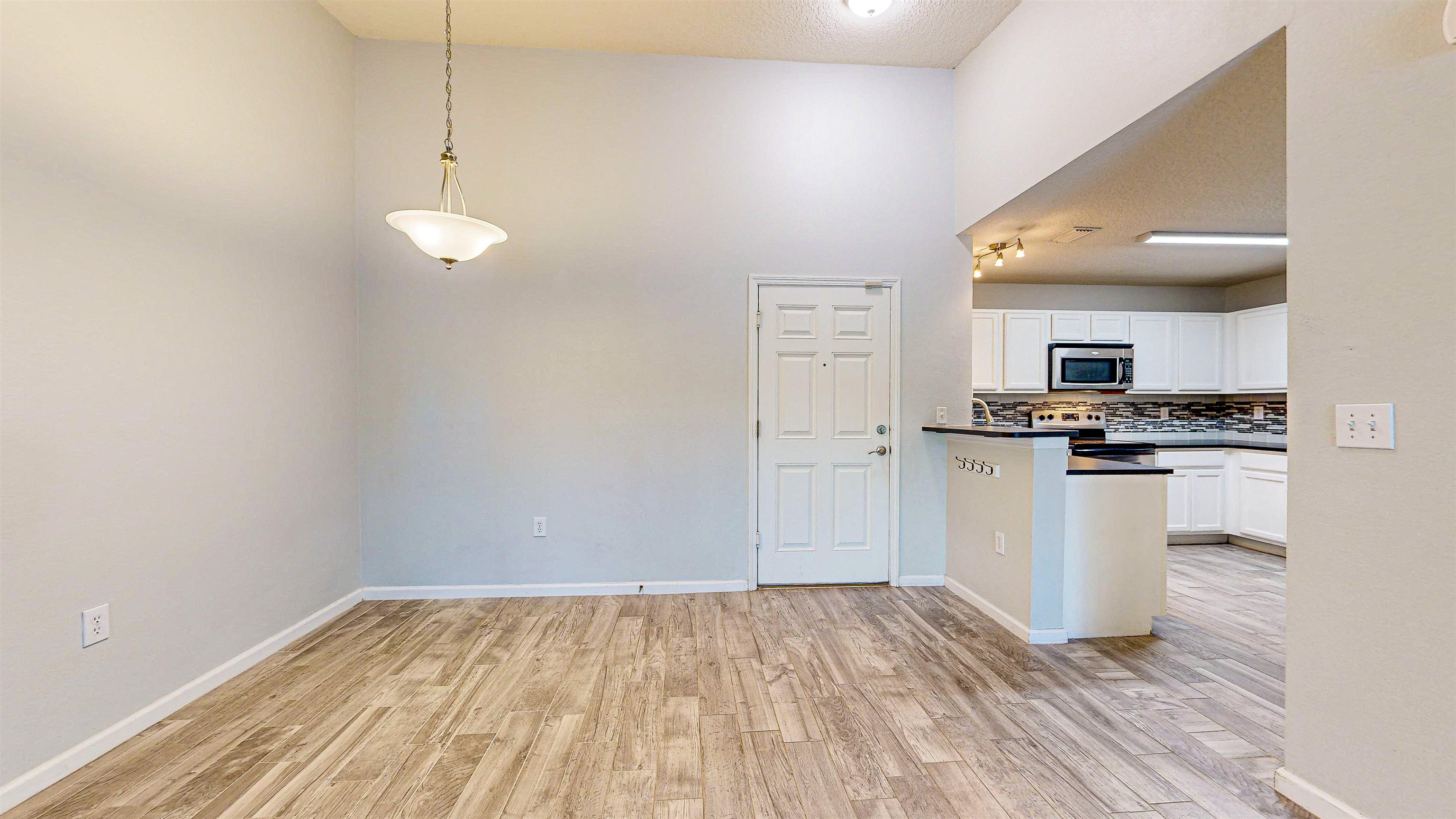 2724 Golden Lake Loop St. Augustine, FL 32084 - Photo 8 of 43 a view of kitchen with microwave and white cabinets