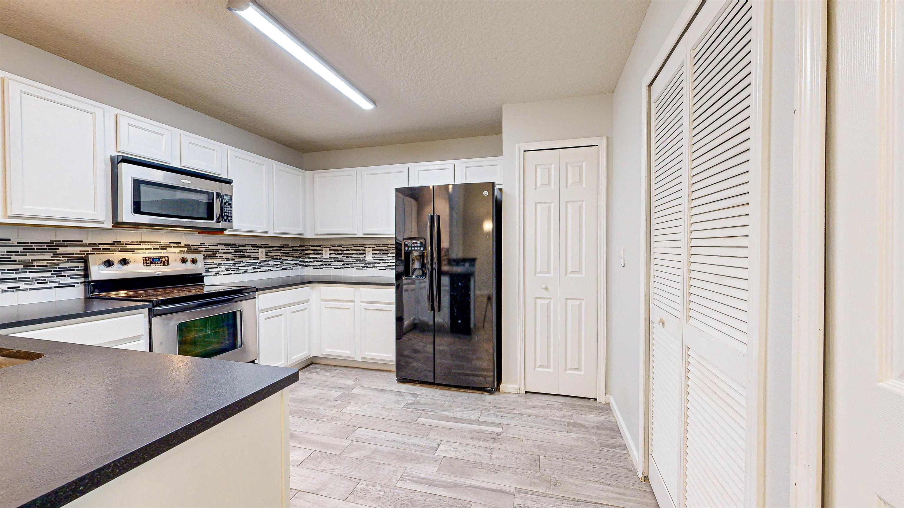 2724 Golden Lake Loop St. Augustine, FL 32084 - Photo 9 of 43 a kitchen with stainless steel appliances granite countertop a refrigerator and a stove