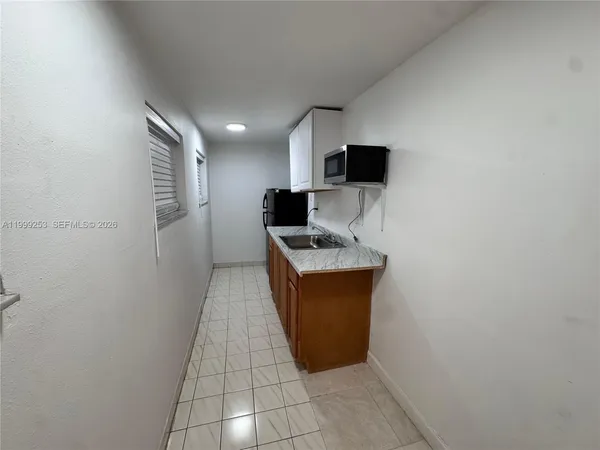 a view of kitchen with microwave and cabinets