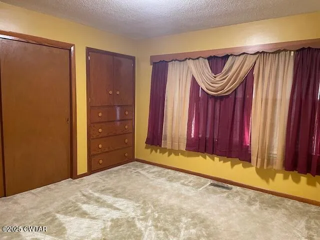 a view of a door and a closet in a bedroom