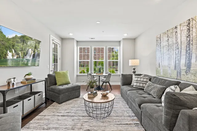 a living room with furniture and a large window