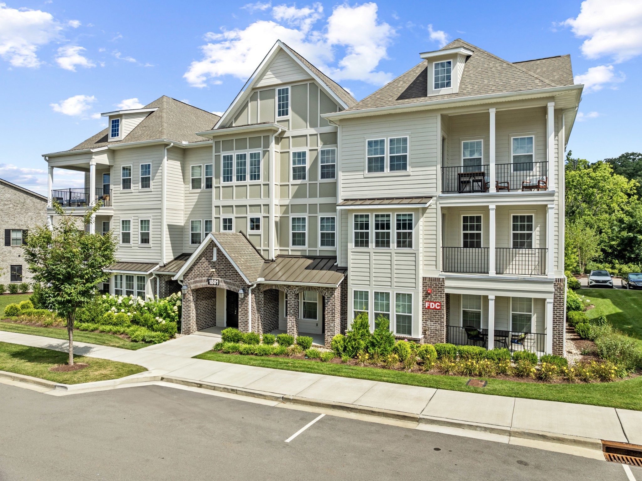 front view of a brick house with a yard